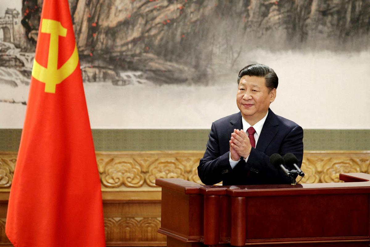 FILE PHOTO: Chinese President Xi Jinping claps after his speech in Beijing