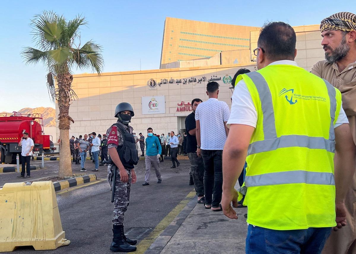 People stand outside a hospital after toxic gas leak from a storage tank in Jordans Aqaba port