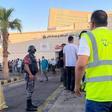 People stand outside a hospital after toxic gas leak from a storage tank in Jordans Aqaba port