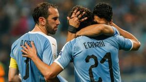 Suárez y Godín se abrazan a Cavani en un partido de la selección de Uruguay