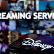 FILE PHOTO: A smartphone screen showing the Disney+ logo is seen in front of the words streaming service in this illustration