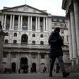 FILE PHOTO: People walk outside the Bank of England in the City of London financial district