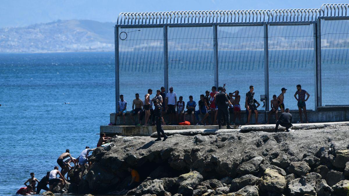 Un grupo de migrantes marroquíes en las inmediaciones de la valla de Ceuta. / EP
