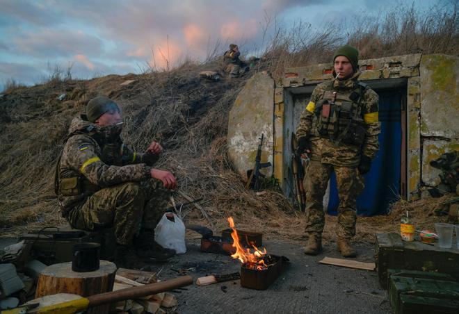 Ukrainian servicemen are seen at fighting positions at the military airbase Vasylkiv in the Kyiv region